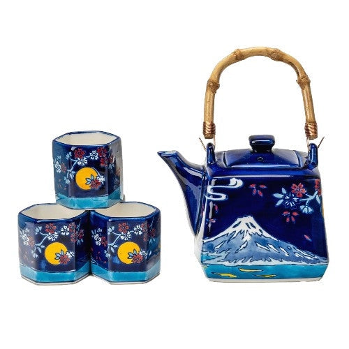 Ceramic teapot with bamboo handle and four cups featuring Mt. Fuji, cherry blossoms, and a full moon under a night sky.