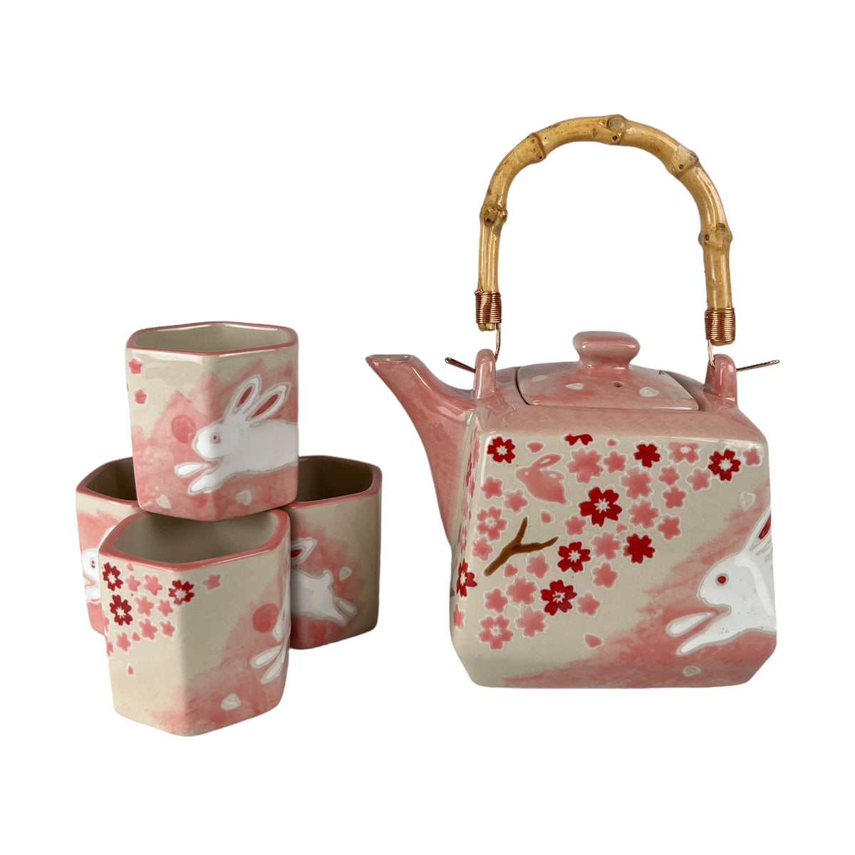 Square ceramic teapot with bamboo handle and four matching cups, featuring pink cherry blossoms and white rabbits.
