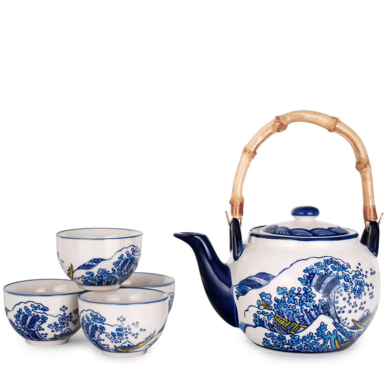 A Japanese-style blue and white ceramic tea set with a bamboo handle on the teapot, featuring intricate blue patterns on a white background.