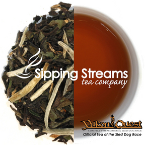 Sipping Streams Tea Company logo over a split image of loose leaf tea and a cup of tea with the Yukon Quest logo in the lower right corner.