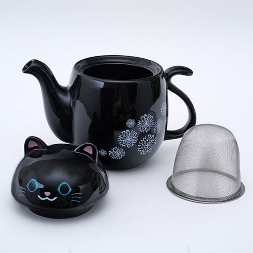 Black cat teapot with snowflake design and a strainer.