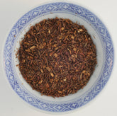 Loose leaf Rooibos Tea (Red Bush Tea)  displaying its unique reddish-brown color, perfect for a caffeine-free relaxation and allergy relief.
