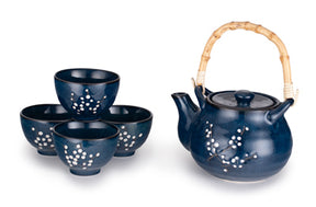 A cherry blossom tea set featuring a ceramic teapot with a natural bamboo handle and four matching cups.